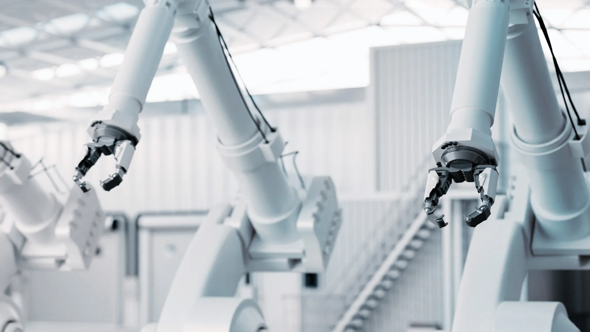 Industrial goods – robotics White robotic arms in white industrial hall