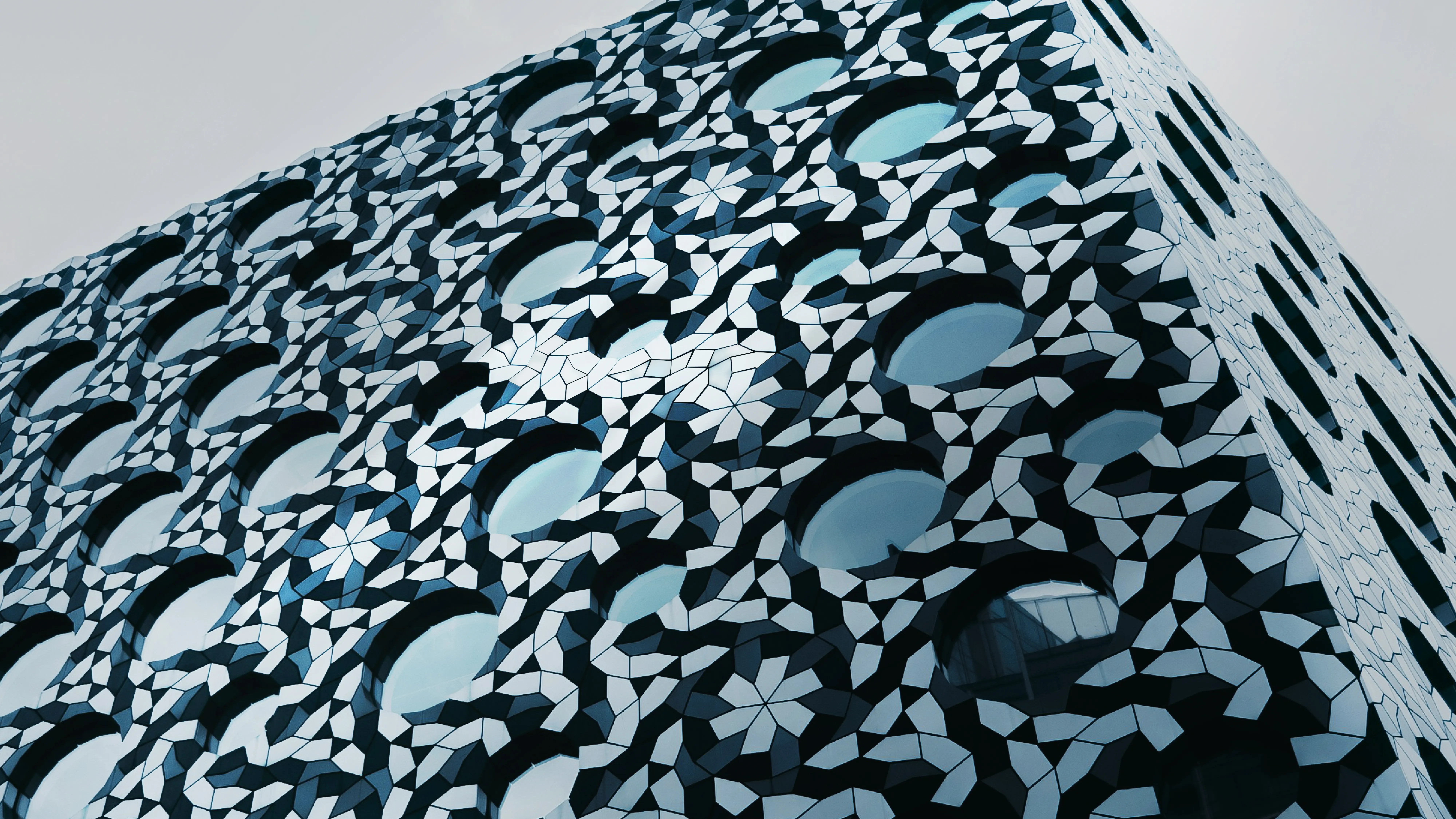 Strategy & architecture Building with abstract mosaic facade and round windows