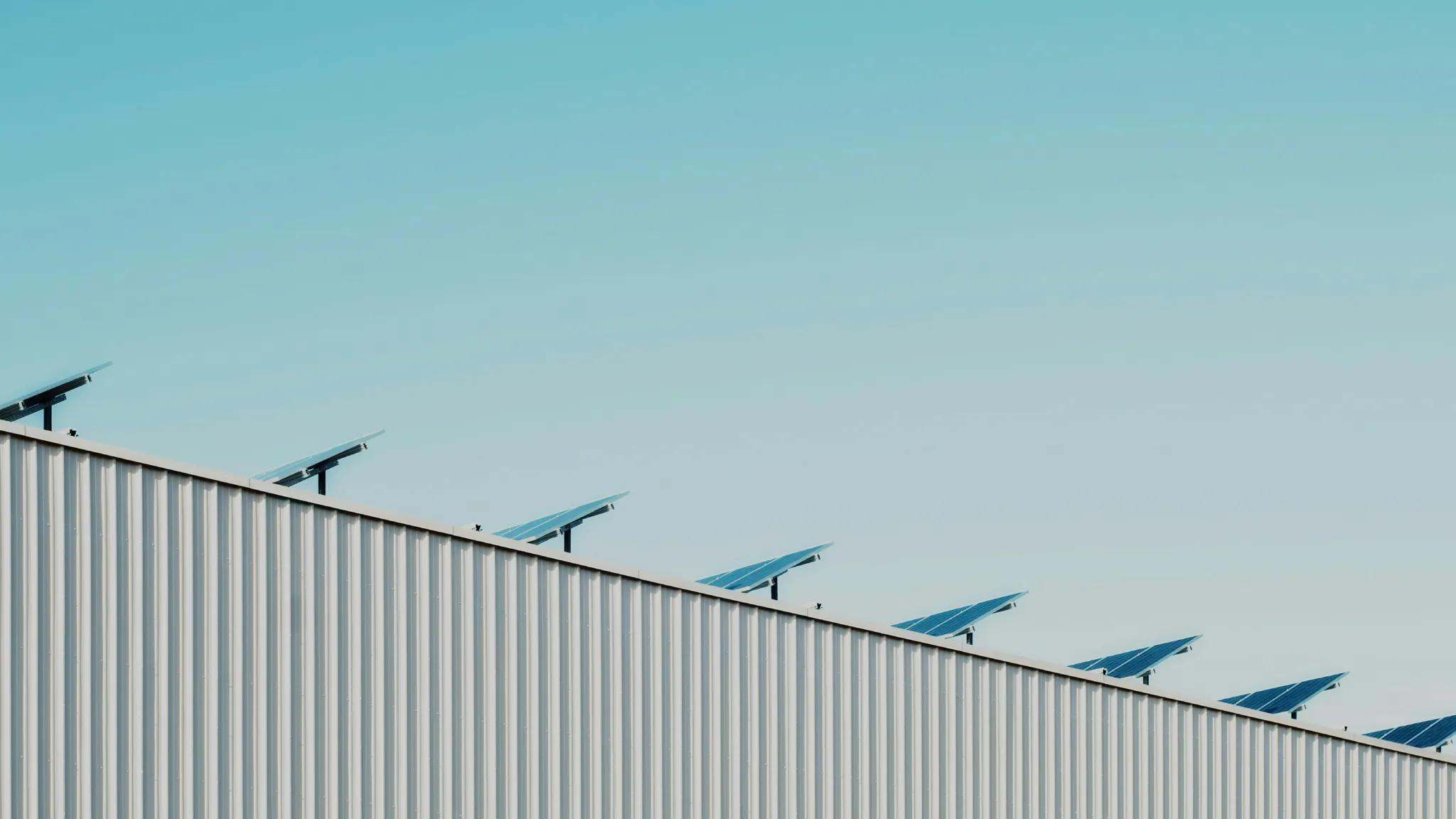 Sustainability and solar energy Hall roof with solar panels under blue sky